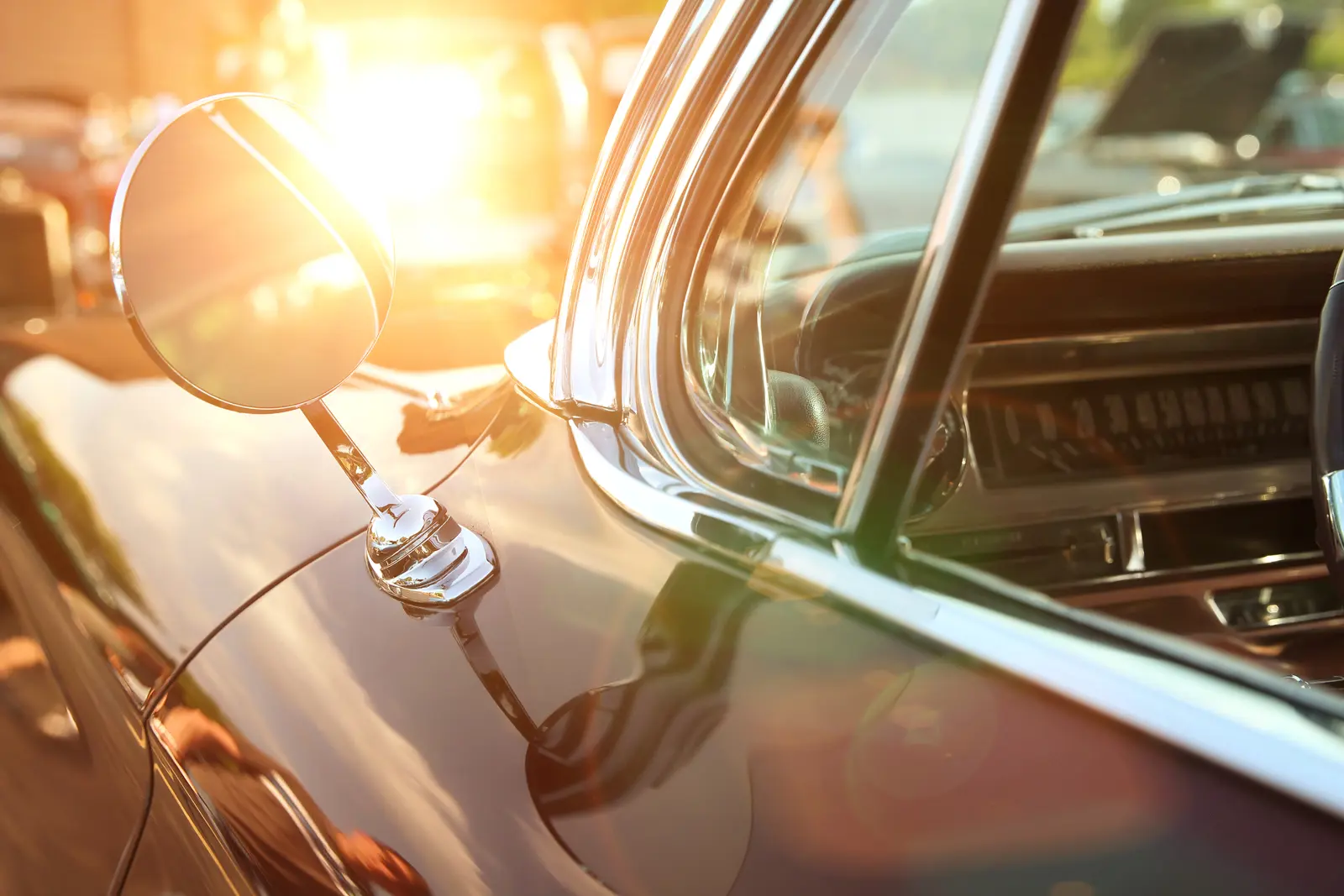 Light shining behind the wing mirror of a classic car