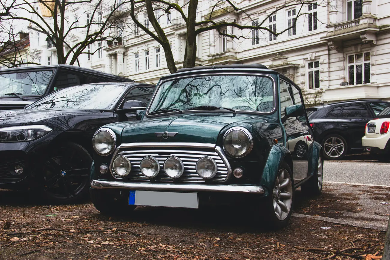 A classic green Mini parked in a central London car park