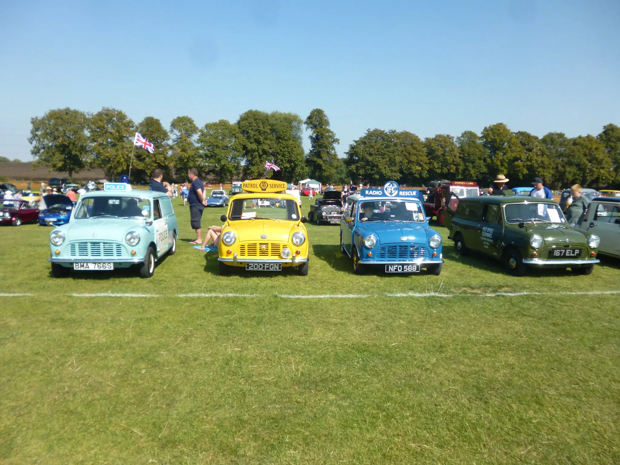 Varying minis lined up on the grass of the park with examples such as the police mini and radio rescue mini