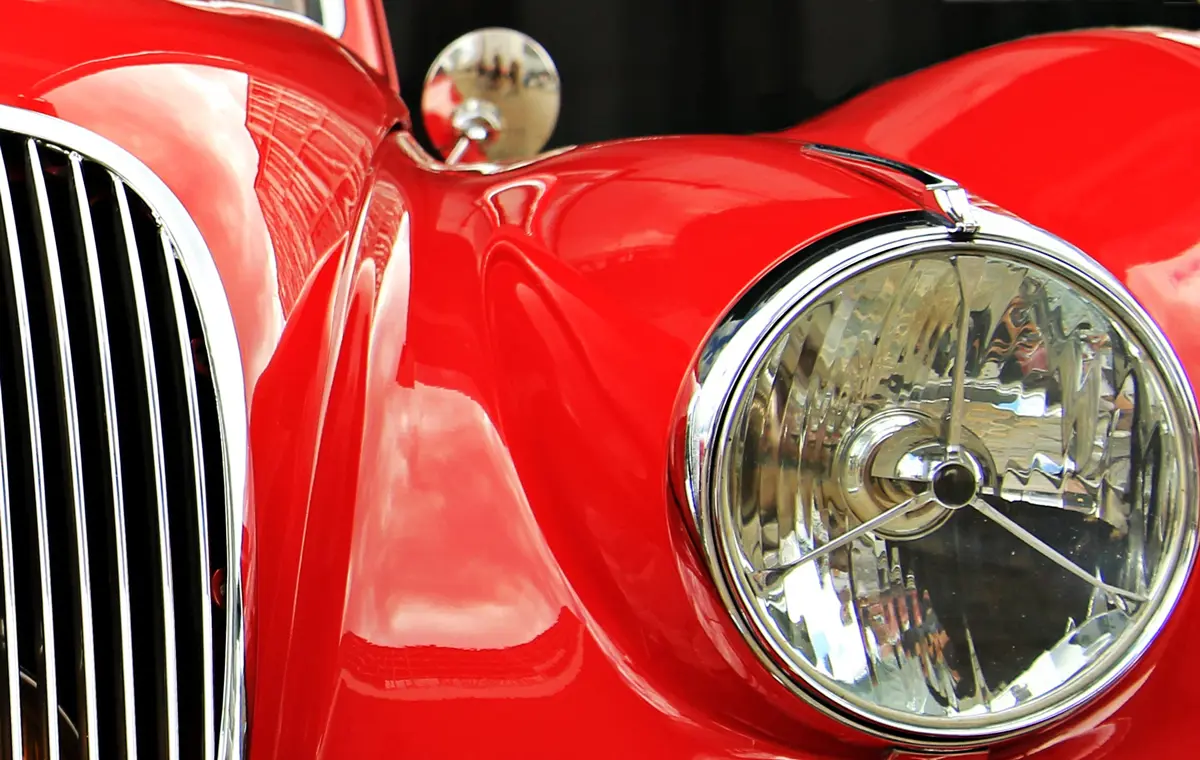 The front headlight of a classic Jaguar