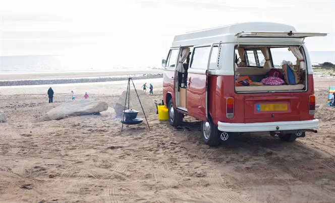 Campervan set up on sandy beach
