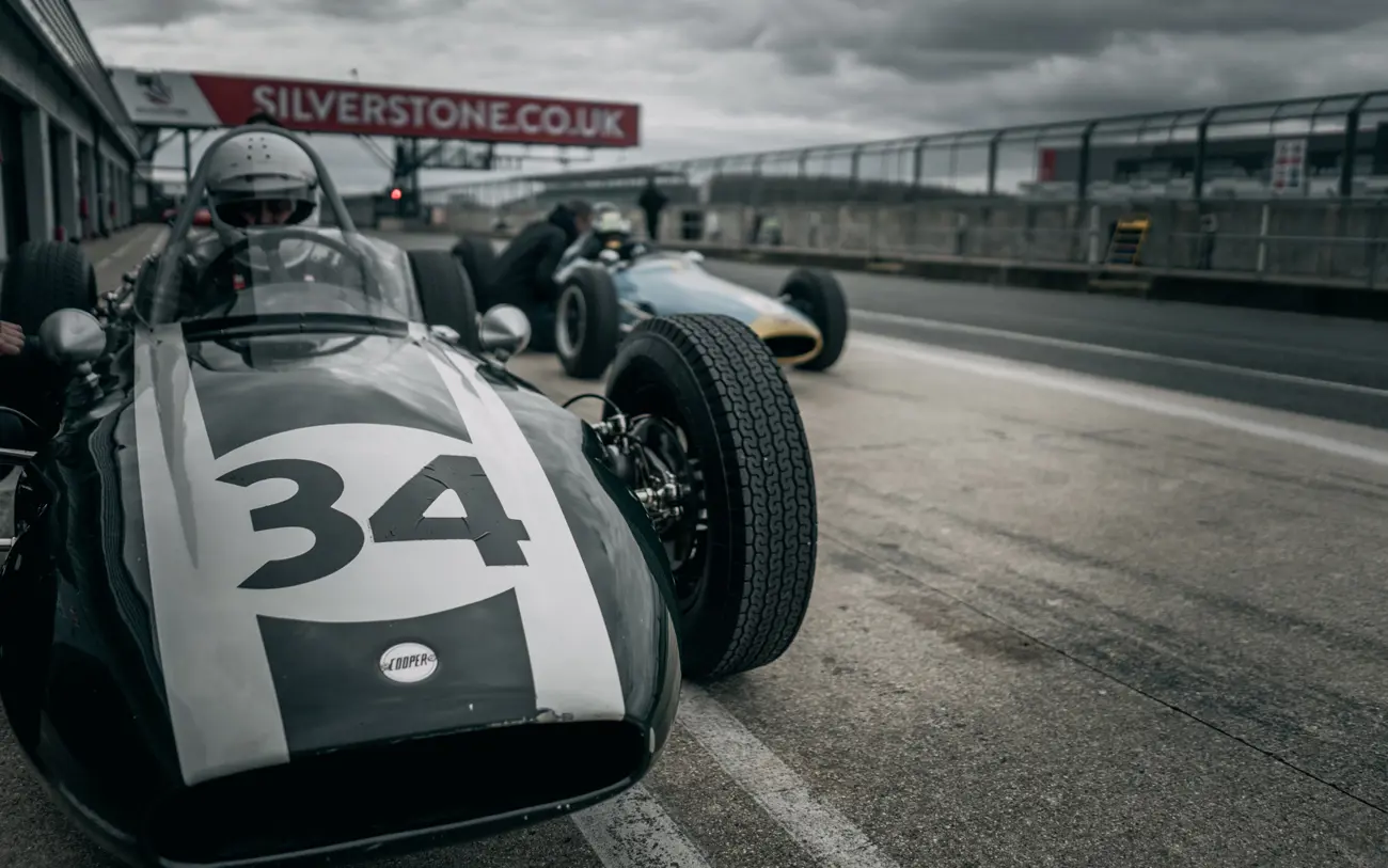 A classic race car parked in the pits at Silverstone racetrack