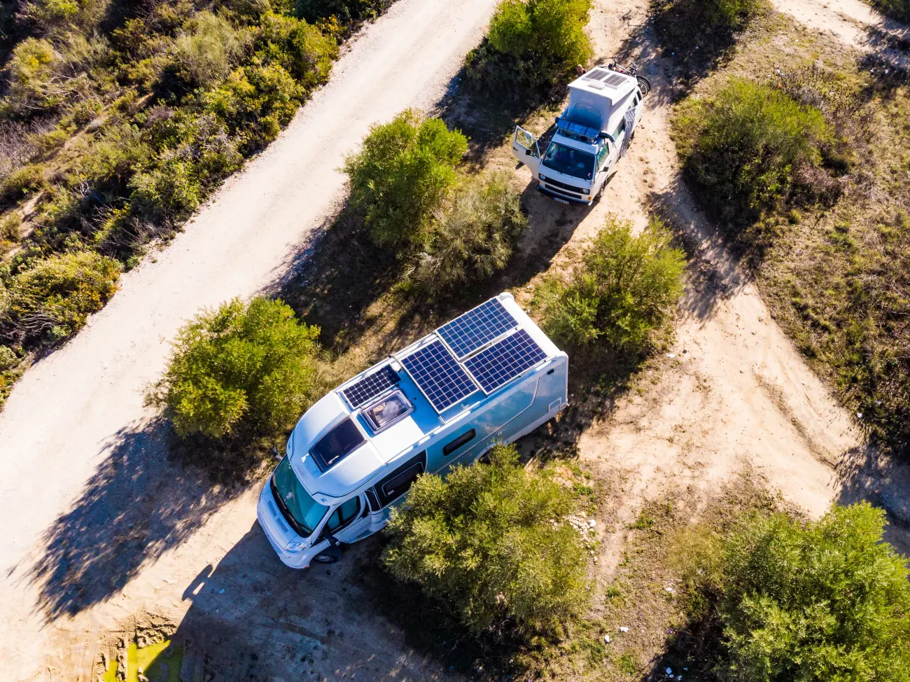 campervans driving with solar panels on the roof