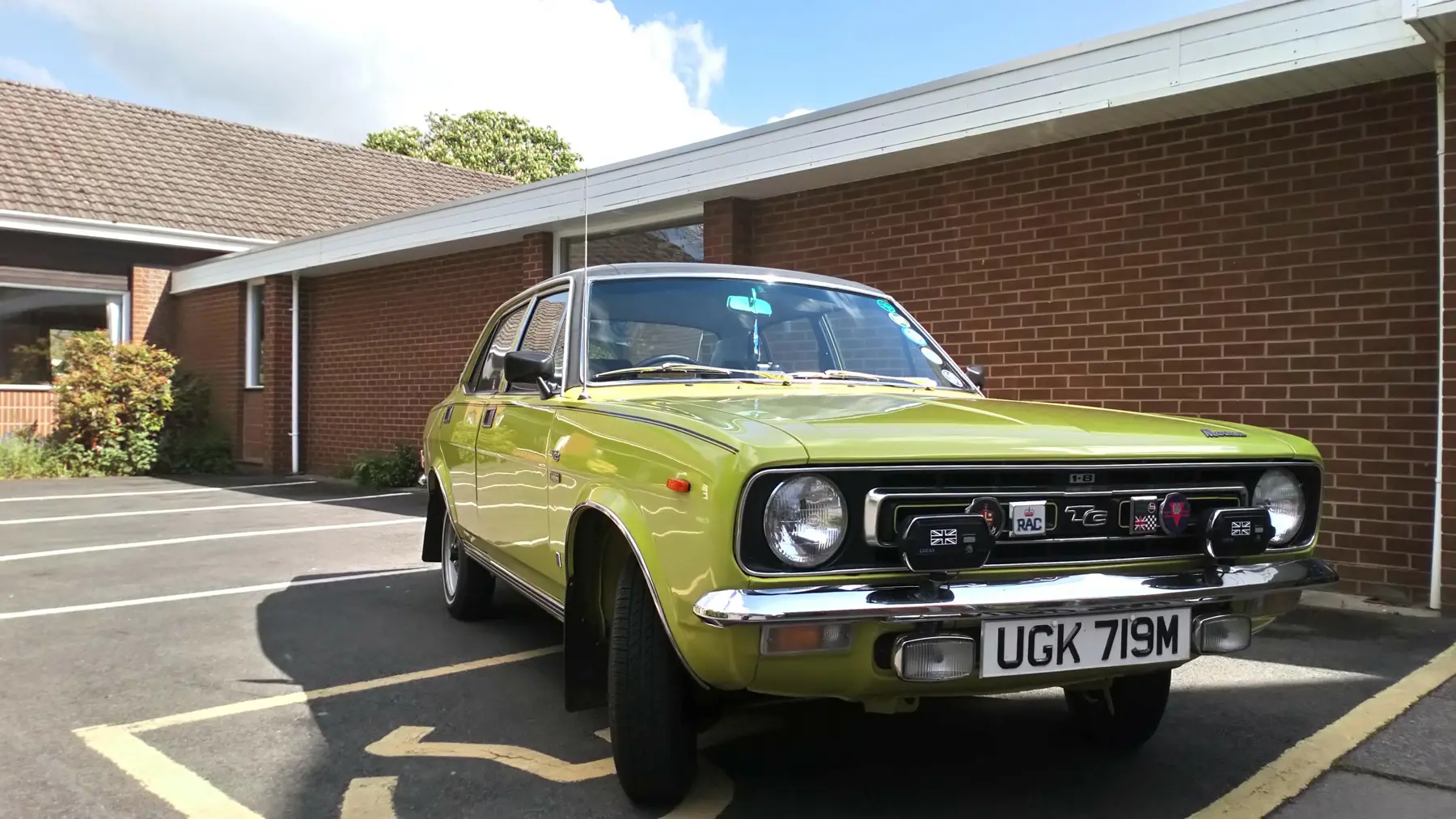 A frontal view of the Morris Marina Jubilee in front of building on a sunny day