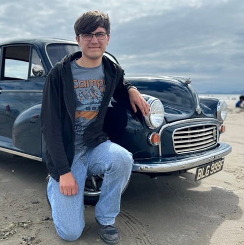 Man kneeling near car
