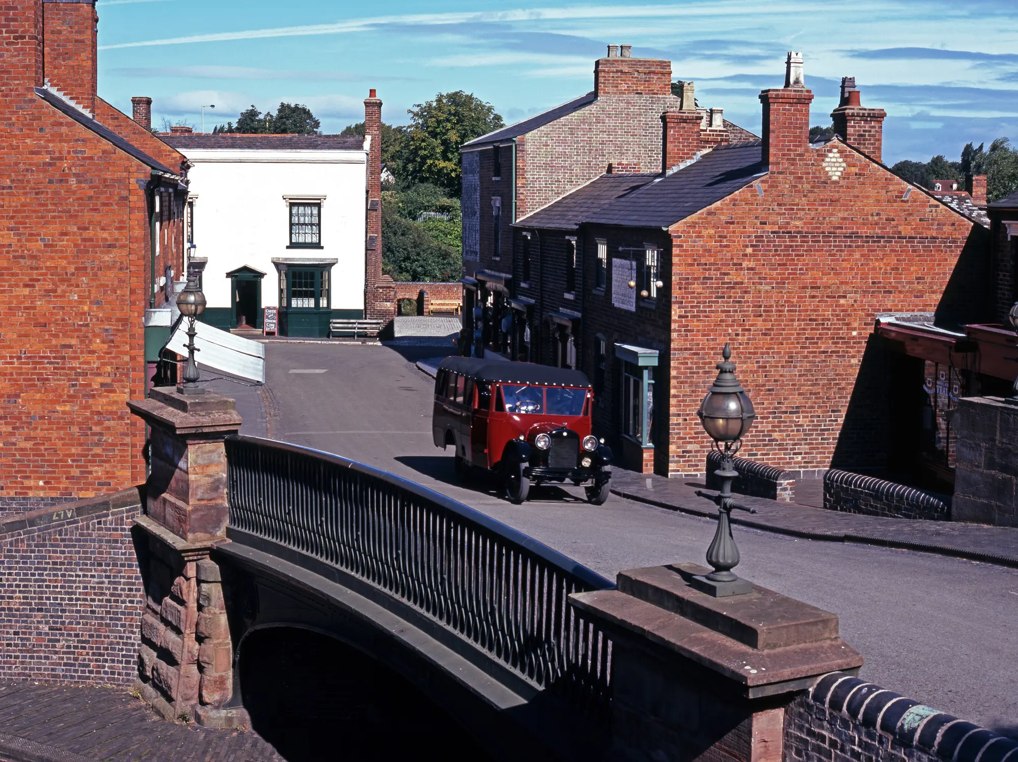 A vintage lorry driving through a quaint British village