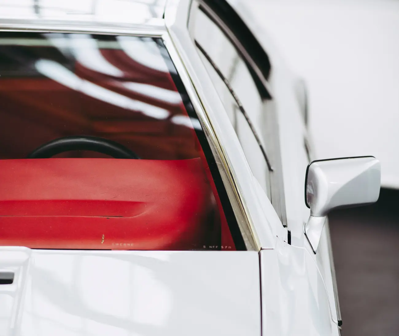The front left side of a Lotus Espirit in a garage