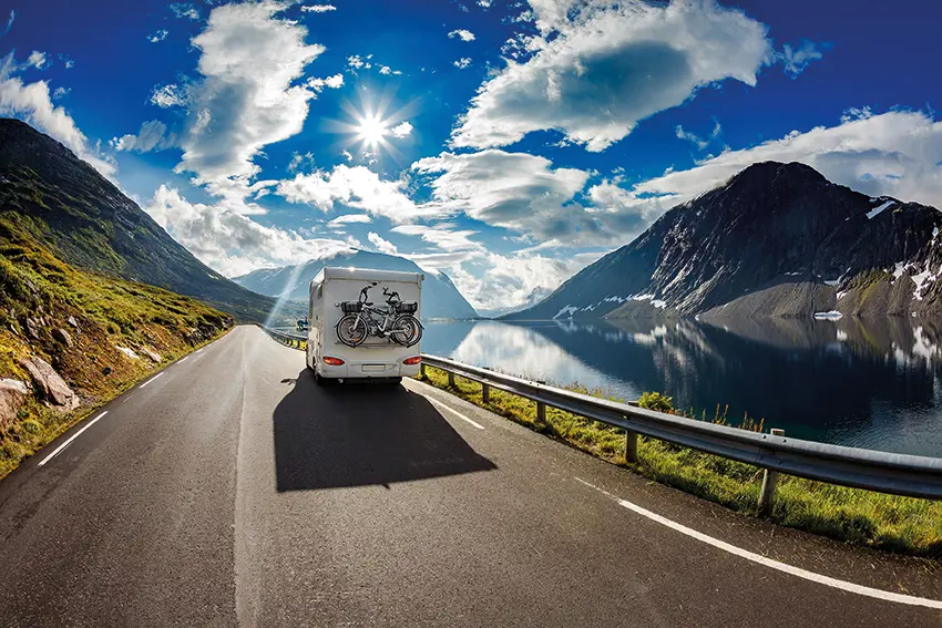 A motorhome travelling along a mountain road in Europe