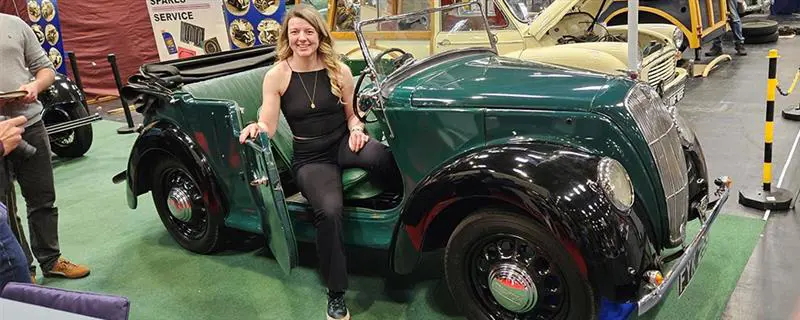 Woman sat in green car