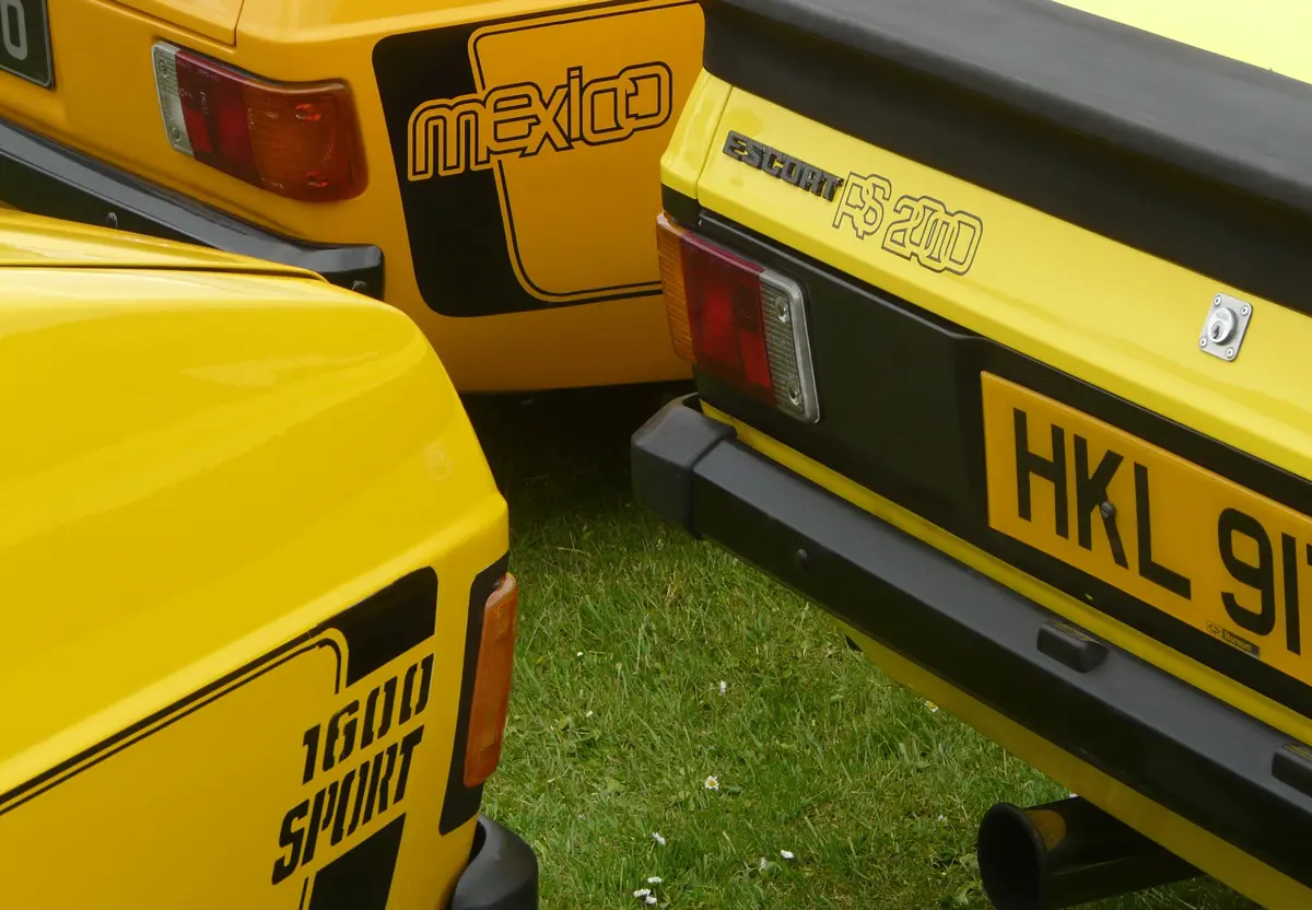 The rear ends of three different versions of the Ford Escort