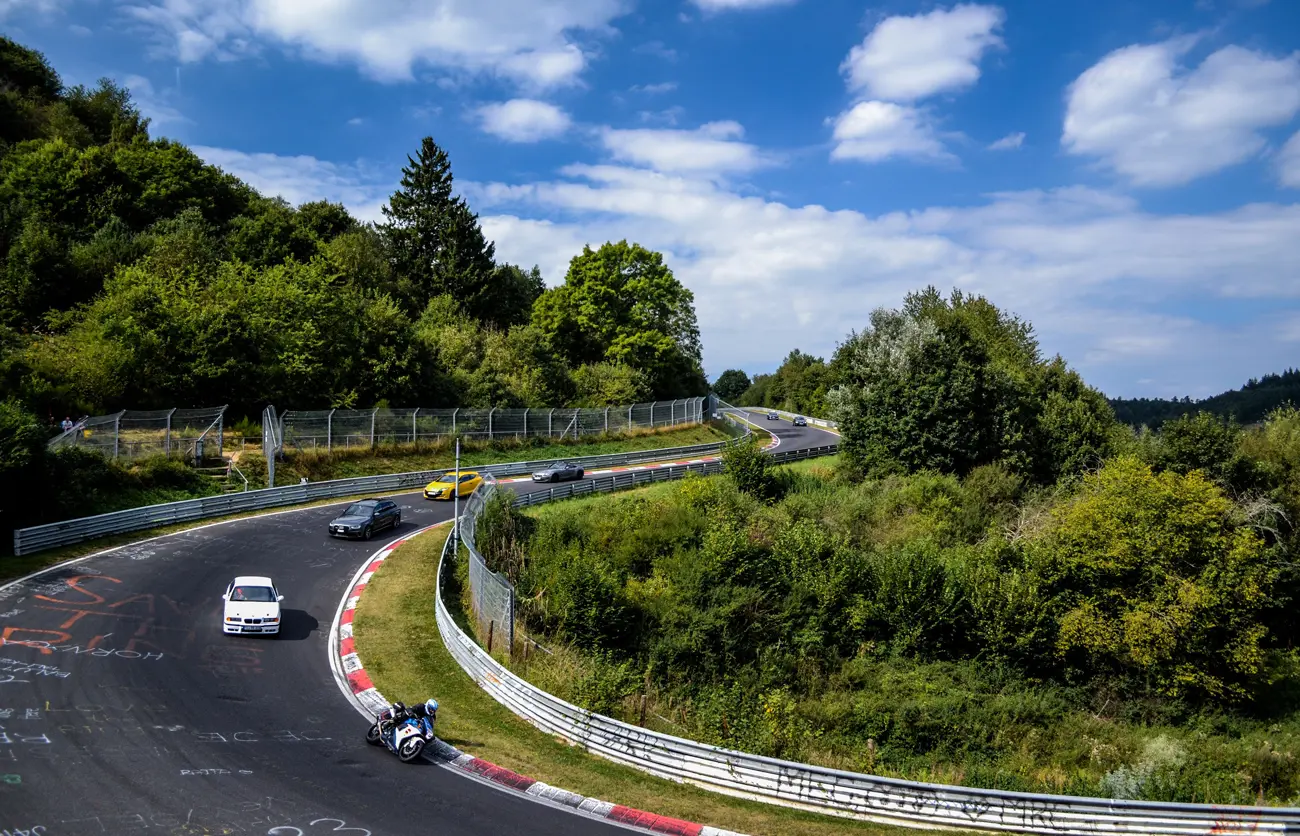 A corner of the track with various vehicles racing