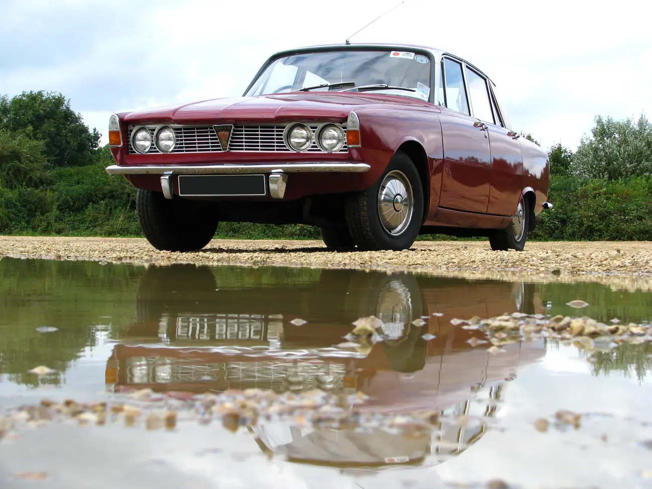 A Rover P6 2000 parked in-front of a large puddle