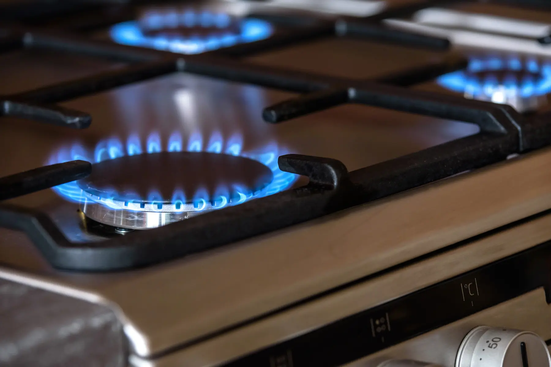 A lit gas hob in a motorhome kitchen