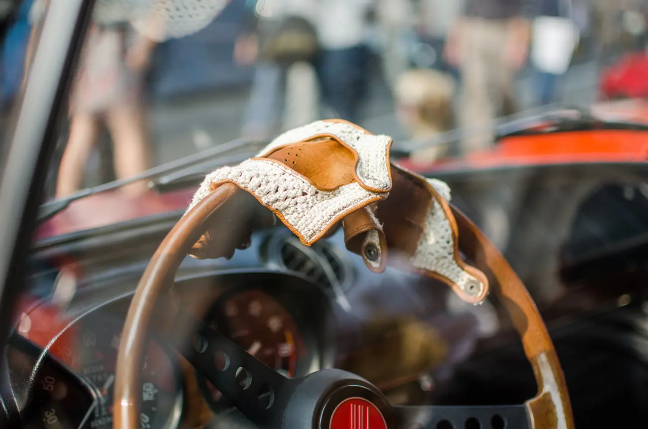 A pair of driving gloves over a steering wheel