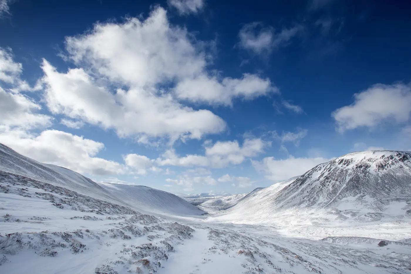 Snow covered mountains stretching into the distance in Cairngorms National Park