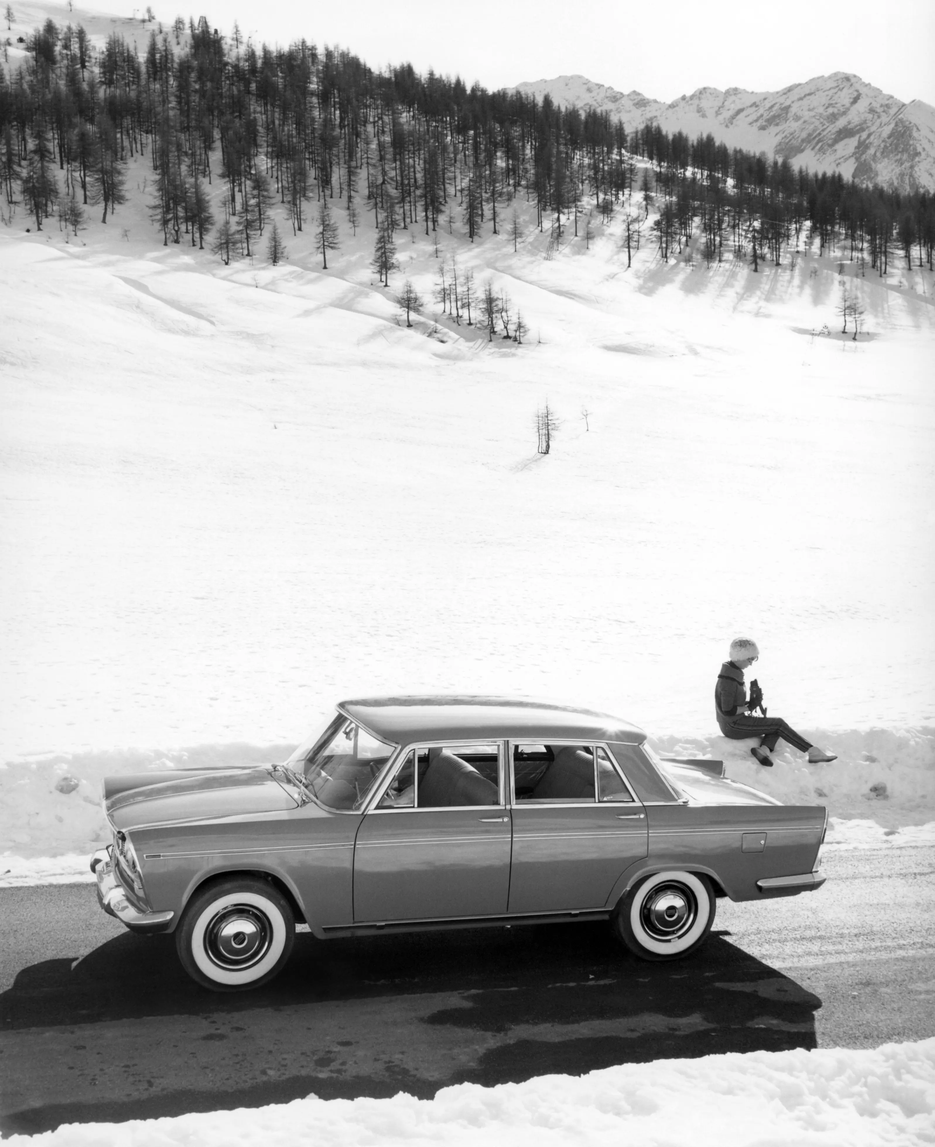 Man on car in snow