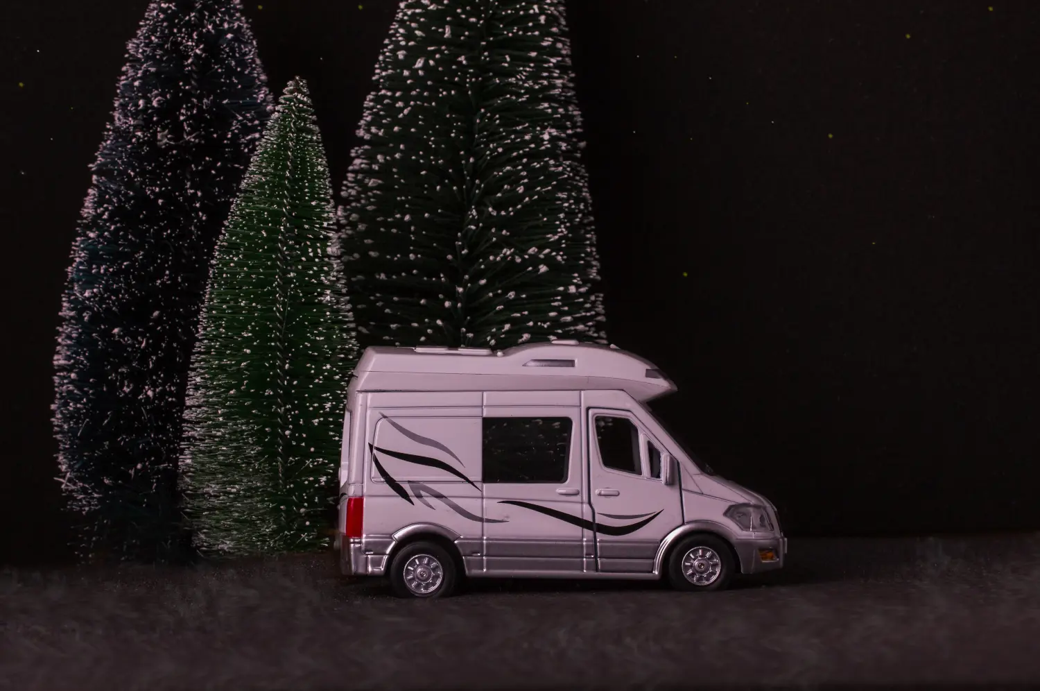 campervan parked next to a christmas tree with lights