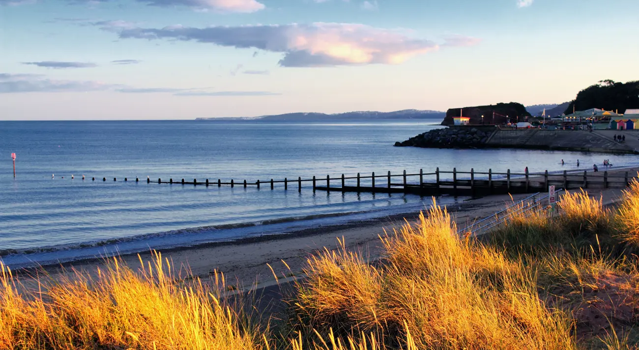 A calm sea on the Devon coast at sunset