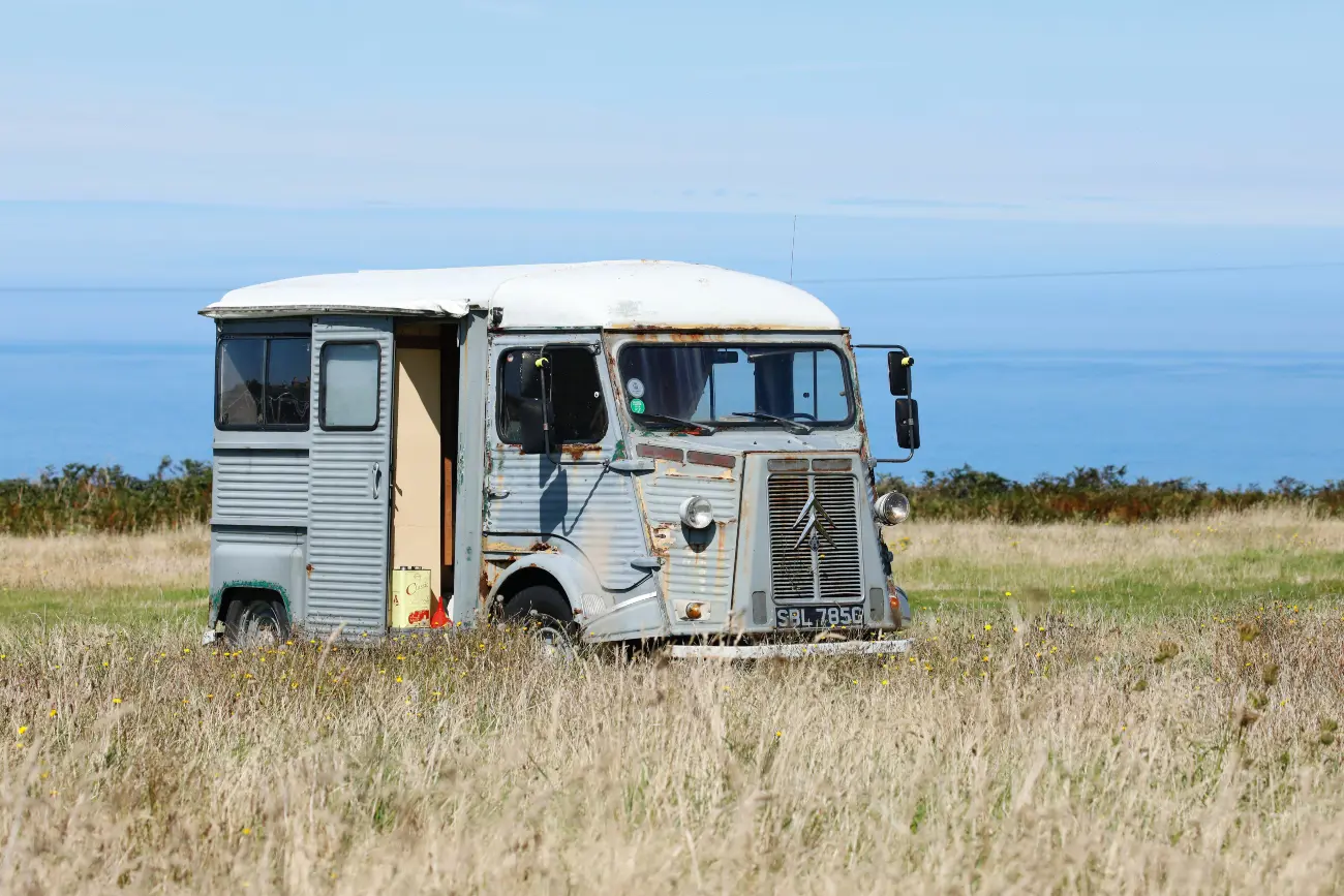Blue Campervan in front of sea