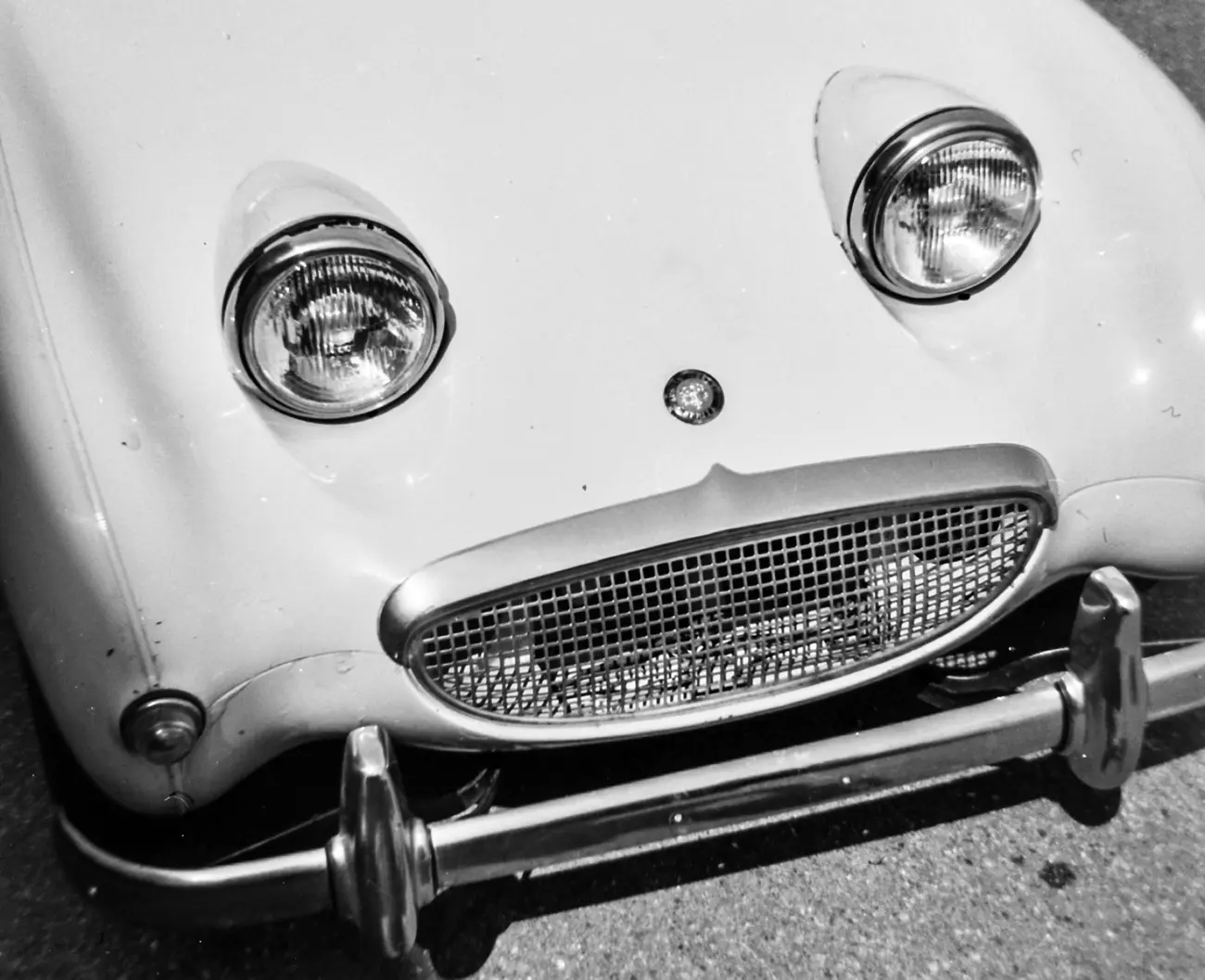 An Austin Healey Sprite under a spotlight