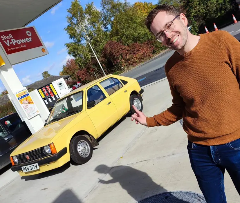Man with yellow car