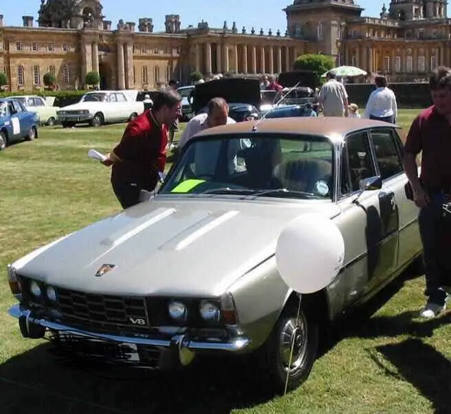 People standing around car